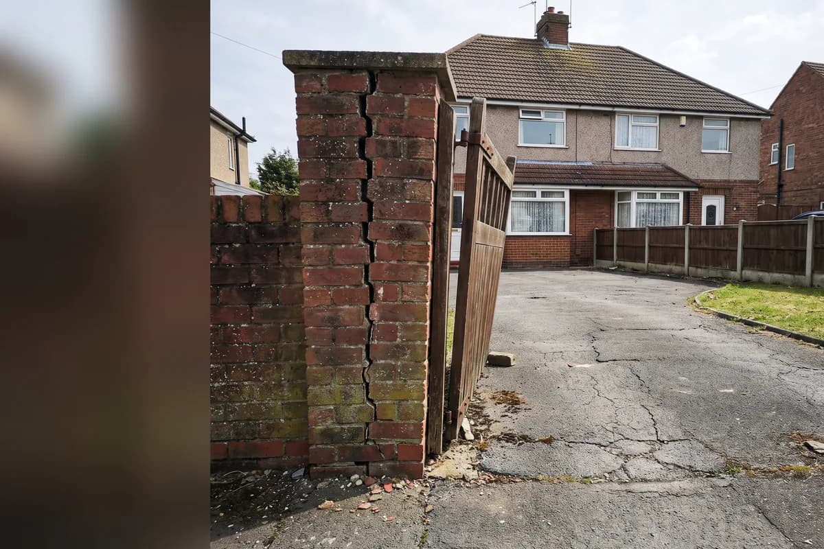 A crack running up from a gate post