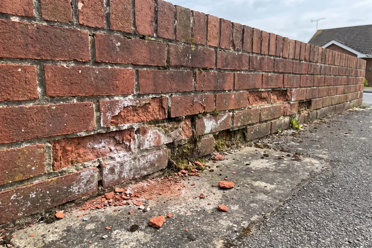 Bricks crumbling low down near the drive