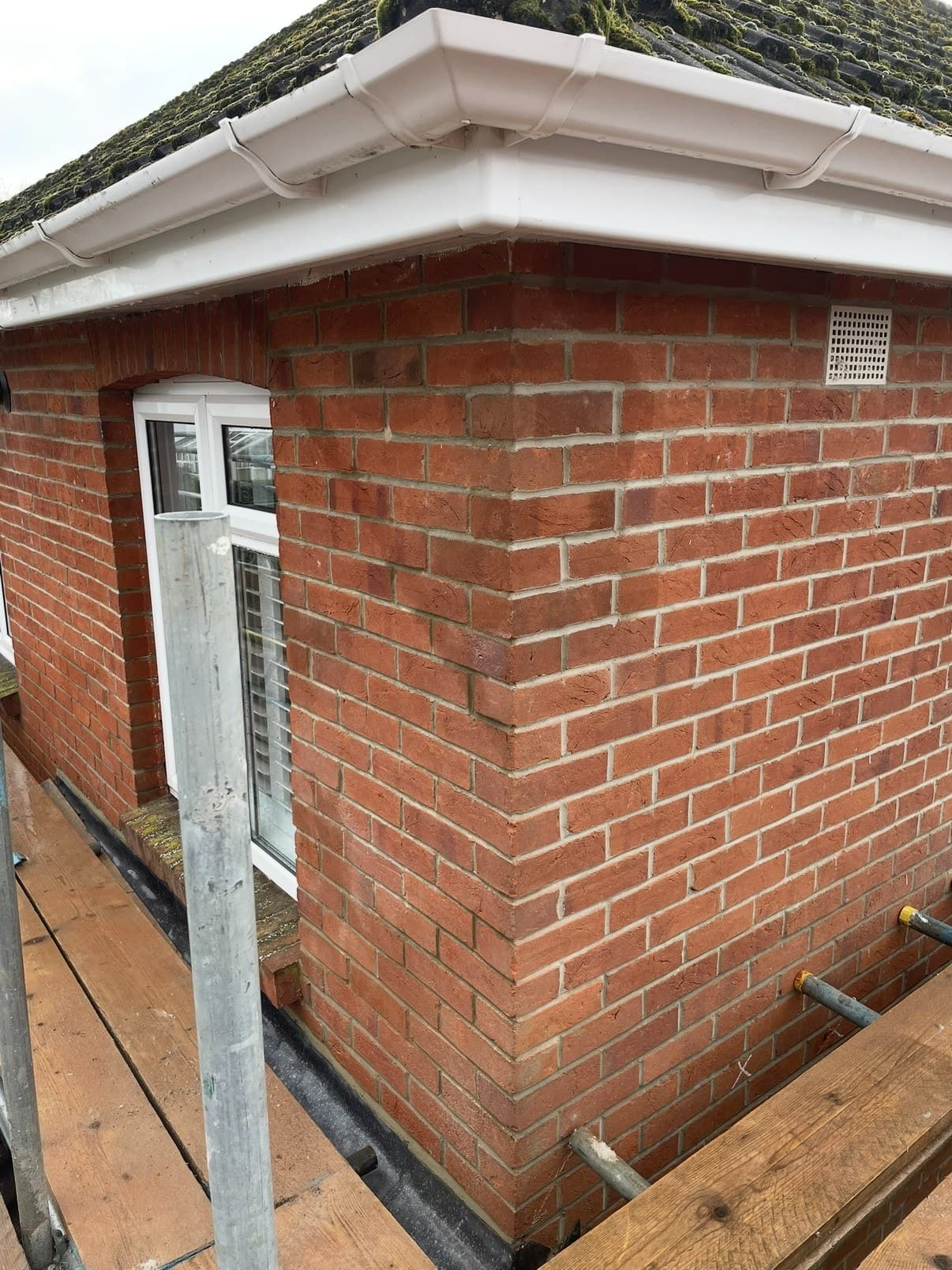The repaired corner, new bricks blended into the original wall