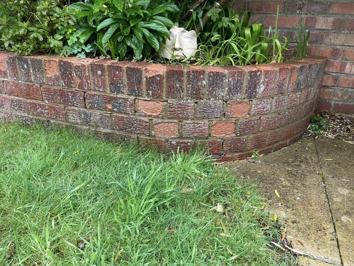 The brick face is flaking or crumbling