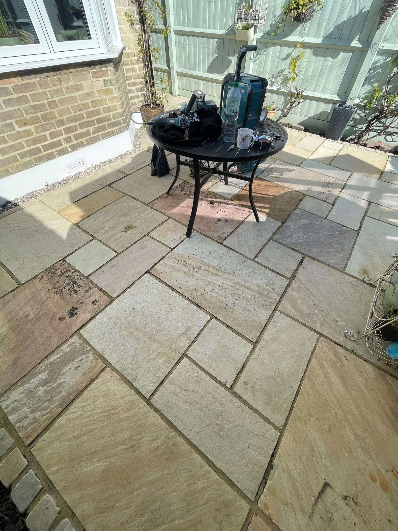 A buff sandstone patio laid out as a seating area