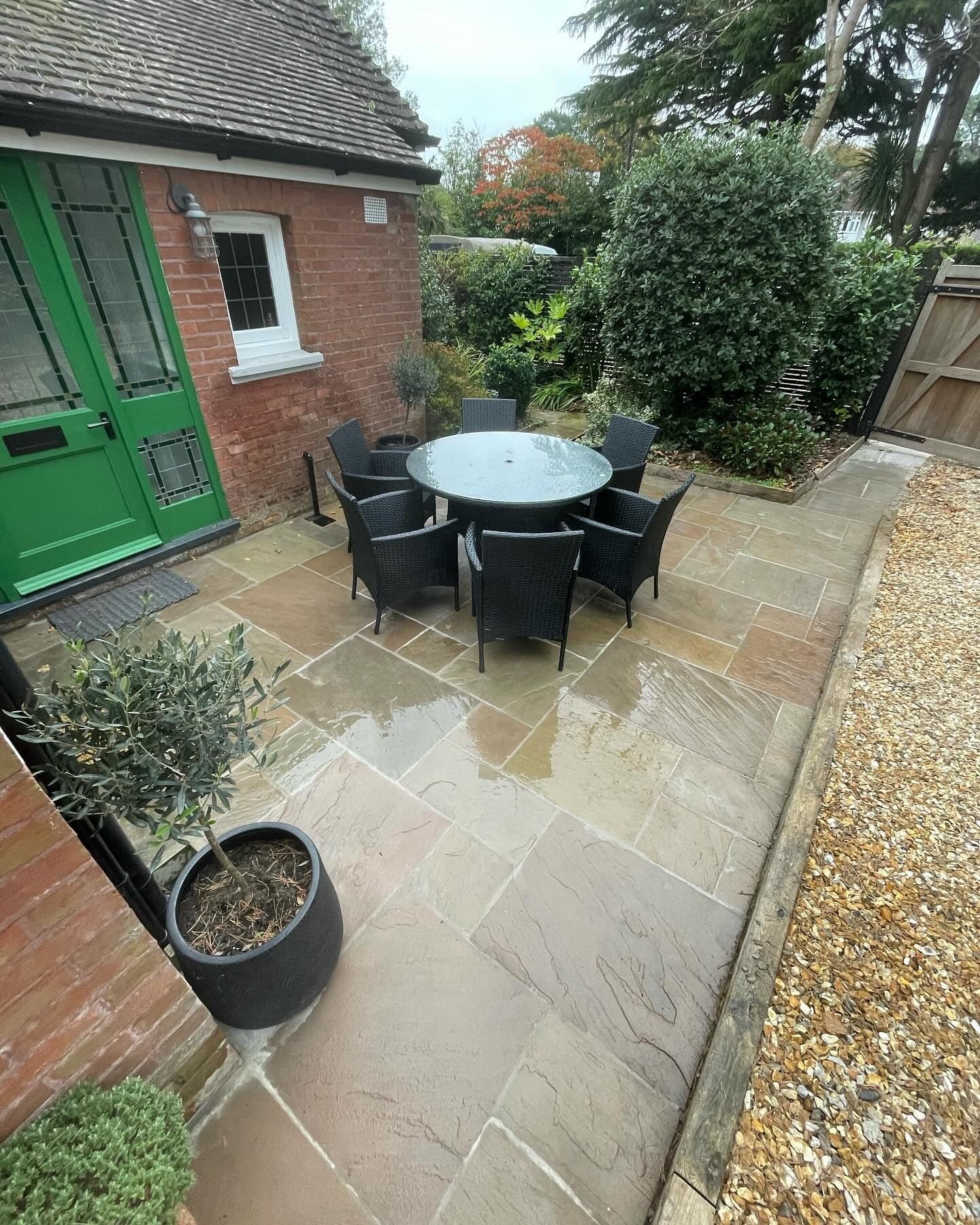 An Indian sandstone patio outside a green front door