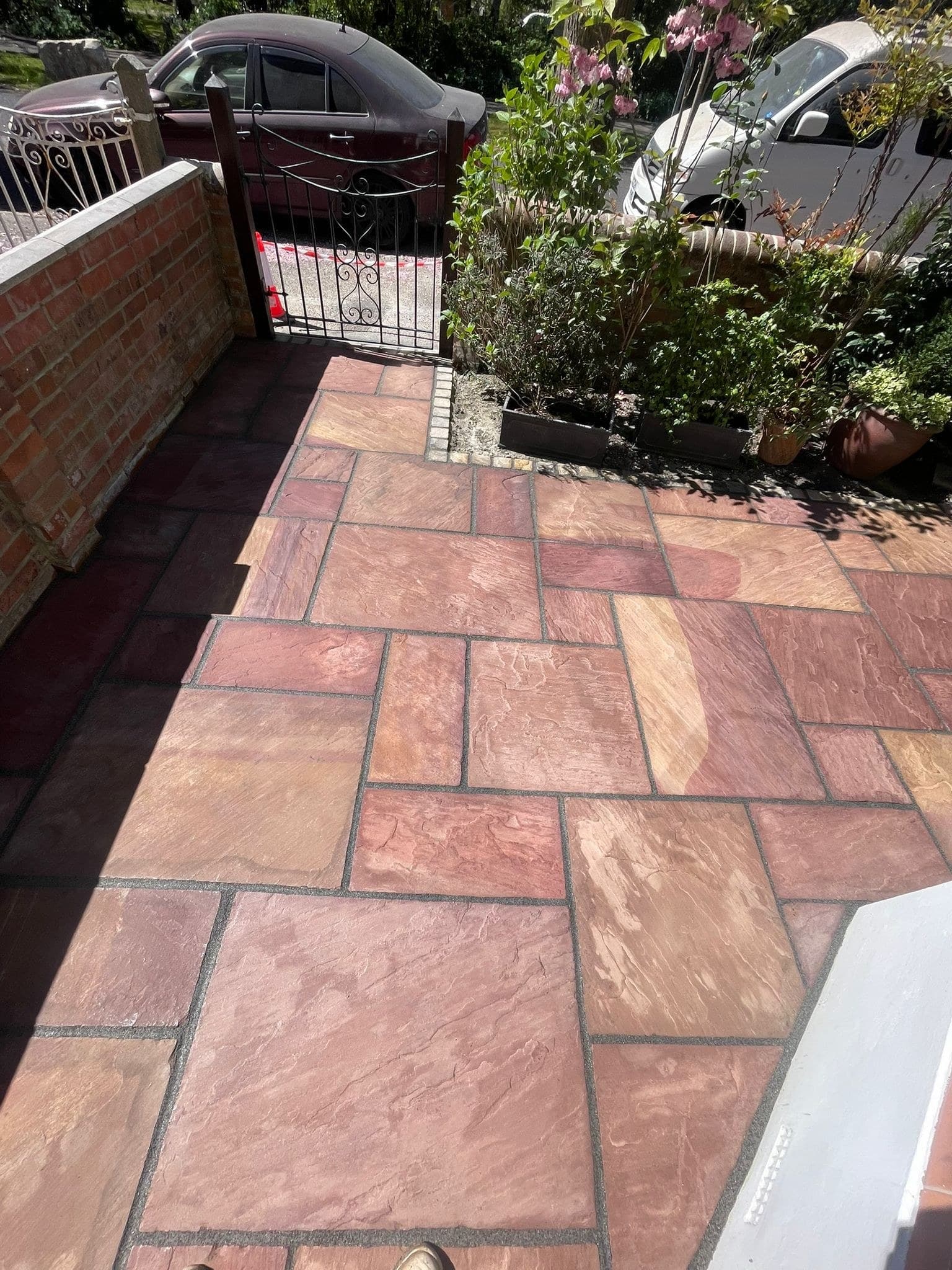 Patio path alongside brick wall